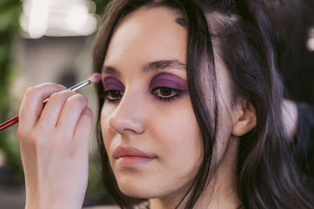 Young woman getting hair styling and makeup in a beauty salon.の写真素材