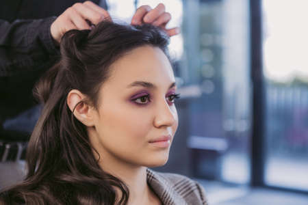 Young woman getting hair styling and makeup in a beauty salon.の写真素材