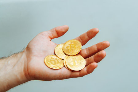 Bitcoins in hand on a light background.の写真素材