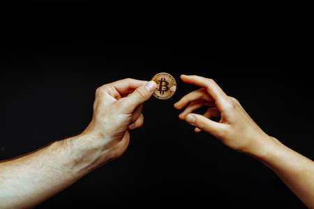 Bitcoin transfer from hand to hand. High quality photoの写真素材