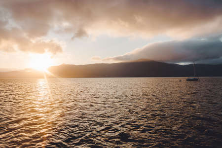 The sun sets over the mountains. Beautiful landscape.の写真素材