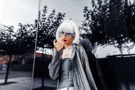 Fashion portrait of a blonde on a red background.の写真素材