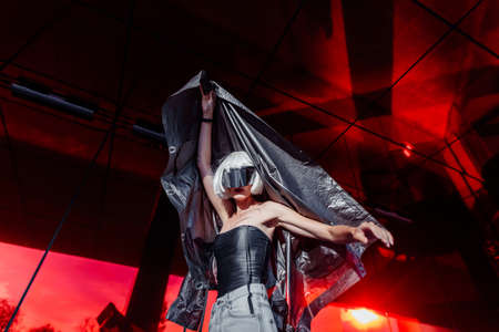 Fashion of the future. Futuristic blonde in red space.の写真素材