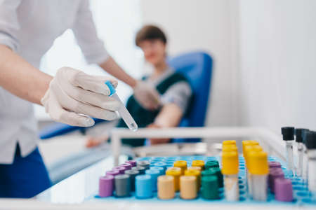 The patient takes a blood test at the clinic.