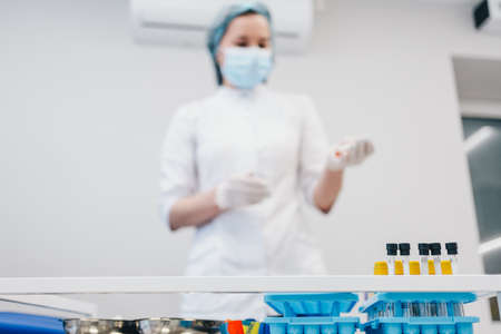 The patient takes a blood test at the clinic.