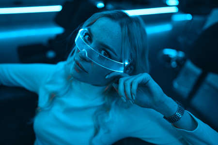 Young woman in neon glasses. Futuristic blonde.の写真素材