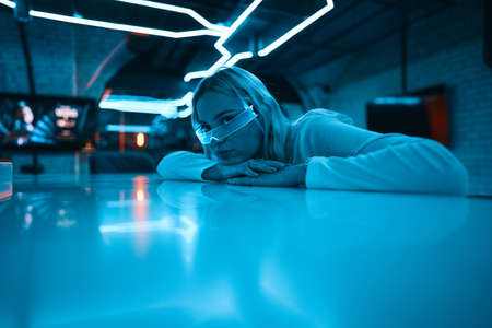 Young woman in neon glasses. Futuristic blonde.の写真素材