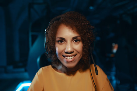 Young curly woman in headphones.の写真素材