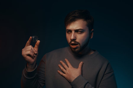 A young man with a bitcoin in his hands. Cryptocurrency.