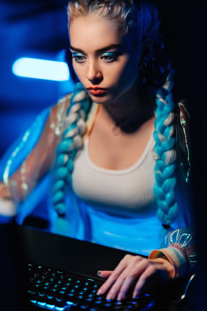 Young female cyber gamer, cosplayer plays computer games.の写真素材