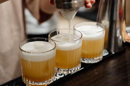 Barnham prepares three yellow cocktails.の写真素材