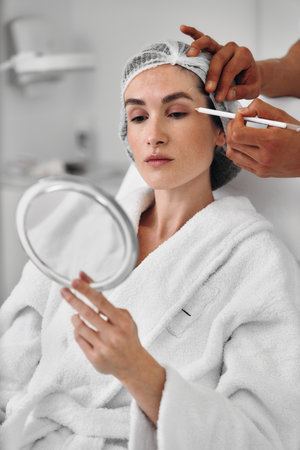 A woman gets injections in the face.の写真素材