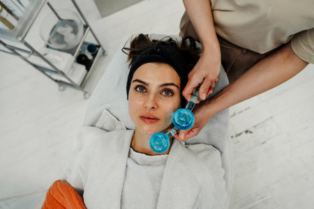 The master gives the client a relaxing facial massage using cold cryo spheres.