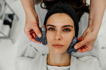 Relaxing facial treatment with massage stones at a spa in a tranquil setting