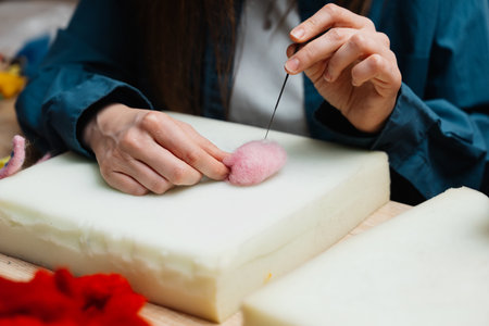 Felting craft demonstration by a skilled artisan in a cozy workshop spaceの写真素材