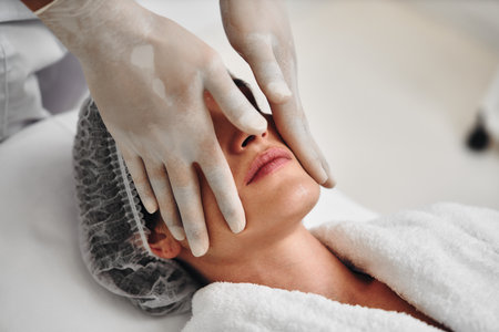 Relaxing facial treatment being performed in a serene spa environmentの写真素材