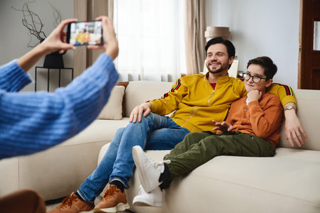 Father and son enjoying quality time together while posing for a photo at homeの写真素材