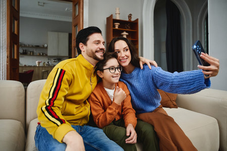 Family enjoys quality time together while taking a selfie at homeの写真素材