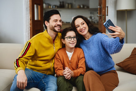 Family taking a cheerful selfie together in cozy living room settingの写真素材