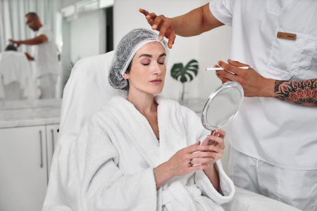Woman receiving a beauty treatment at a modern spa during the dayの写真素材