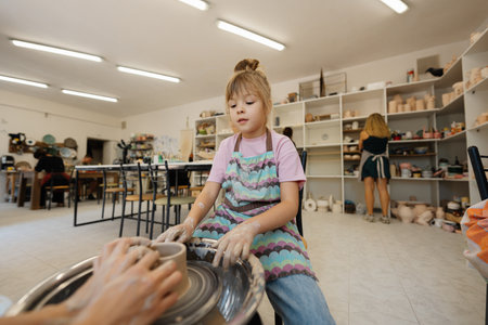 Girl enjoys pottery lessons in a bright studio during the afternoon