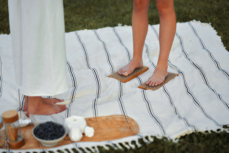 Relaxing wellness session with foot therapy on a blanket in the parkの写真素材