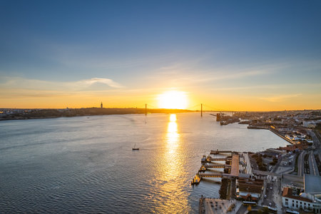 Sunset over the river with a bridge and shoreline in the backgroundの写真素材