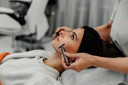 Client receiving facial treatment at a skincare studio on a relaxing dayの写真素材