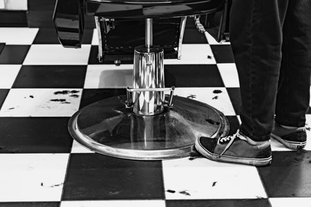 Barbershop floor activity with stylist preparing for haircut serviceの写真素材