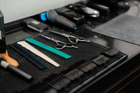 Hair cutting tools arranged neatly on a barber table in a modern salonの写真素材