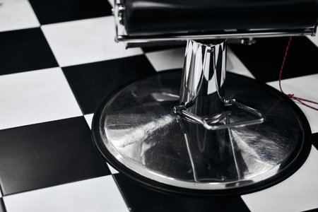 Barber chair on classic black and white checkered floor inside salonの写真素材