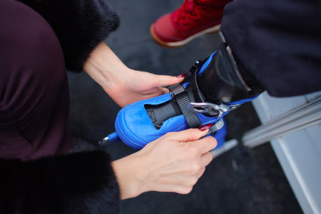 Preparing roller skates for a fun outdoor activity at a park in autumnの写真素材