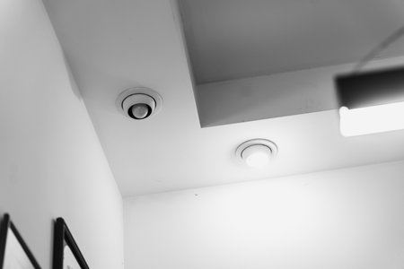 Unique ceiling design featuring modern lighting fixtures in a minimalist roomの写真素材