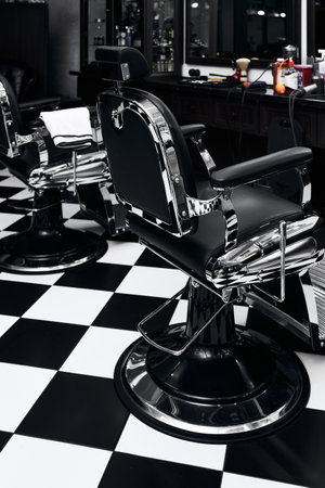 Stylish barber chairs in a modern barbershop with black and white decorの写真素材