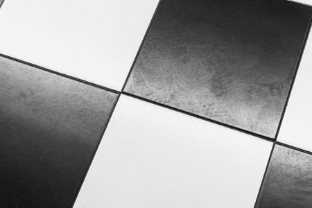 Black and white checkerboard floor pattern in a modern interior spaceの写真素材