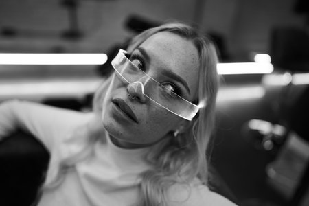 Portrait of a young woman with unique glasses in a stylish interior setting