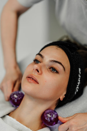 Relaxation therapy session with glass cups on neckの写真素材