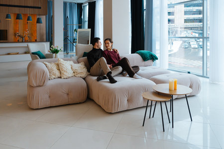 Cozy couple enjoys quality time in modern living room setting