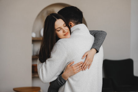 Couple embraces in a cozy indoor setting during a quiet moment