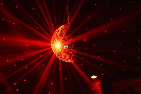 Lavish red lighting with disco ball reflecting bright patternsの写真素材