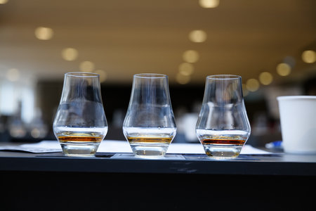 Tasting fine spirits at a distillery in a modern setting during an afternoonの写真素材
