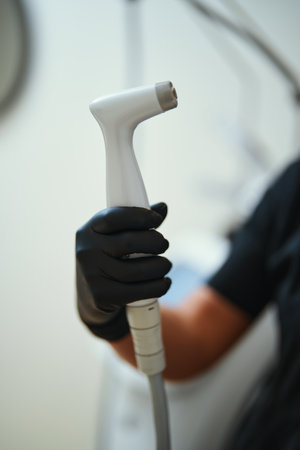 Medical professional holding a handheld device in a clinical setting