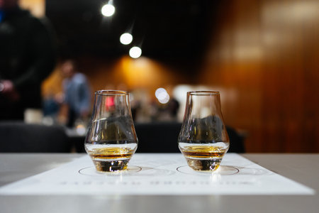 Whiskey tasting experience in a cozy atmospheric bar settingの写真素材