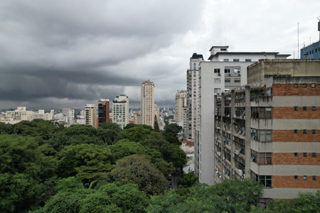 Cloudy urban landscape in Sao Paulo with buildings and lush greeneryの写真素材