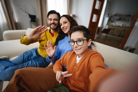 Family enjoying a cozy moment together at home in the living roomの写真素材