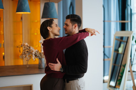 Couple sharing a romantic moment in a cozy modern interior settingの写真素材