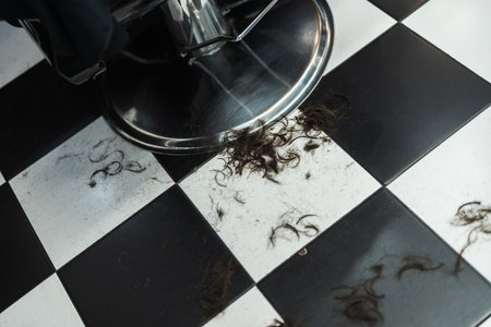Barber shop floor covered in freshly cut hair from recent grooming session