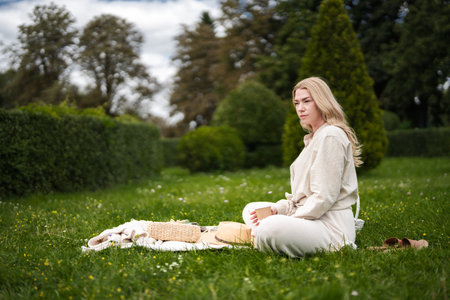 Relaxing afternoon picnic in a lush green garden during springtimeの写真素材