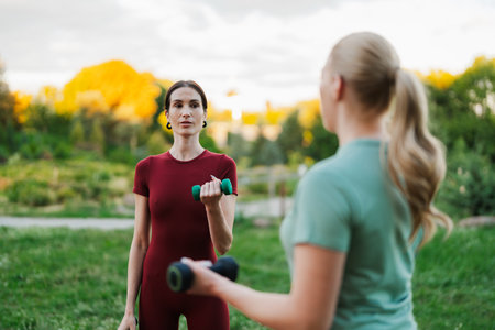 Working out in the park with friends during golden hour for fitness motivationの写真素材