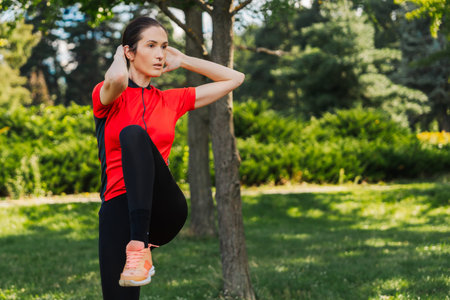 Woman exercises in park during sunny day